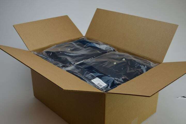 Cardboard box w/ folded jeans wrapped in plastic inside.